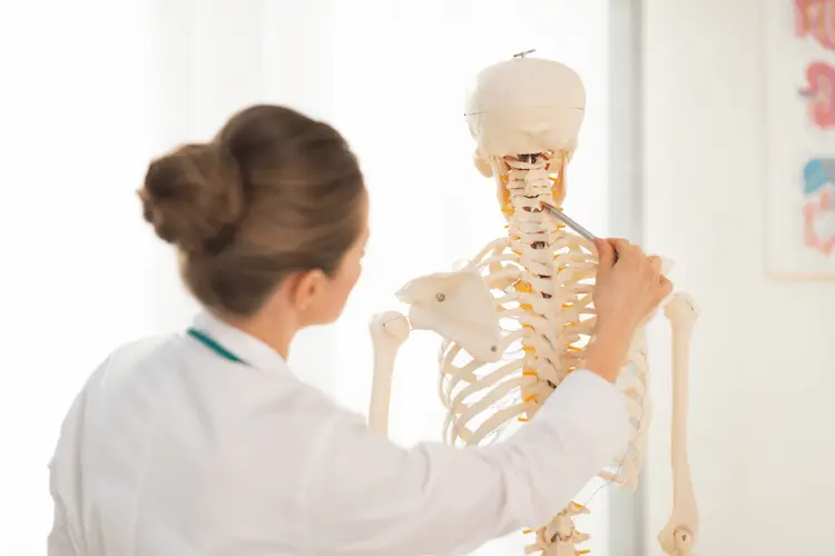 doctor examining spine