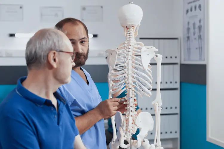 doctor examining spine